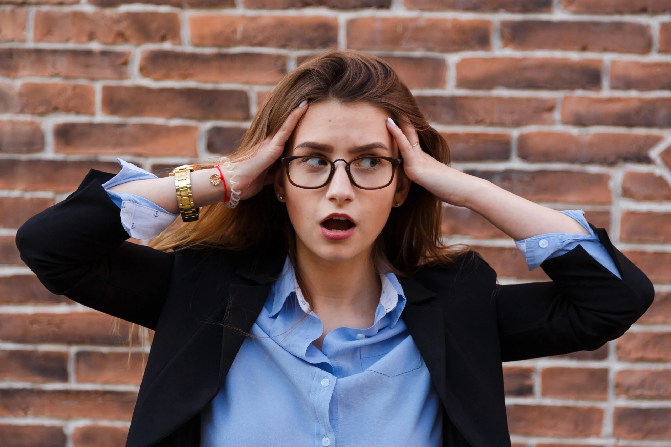 Frustrated business woman holding her hands to her head in frustration. Adobe Bridge vs Daminion.